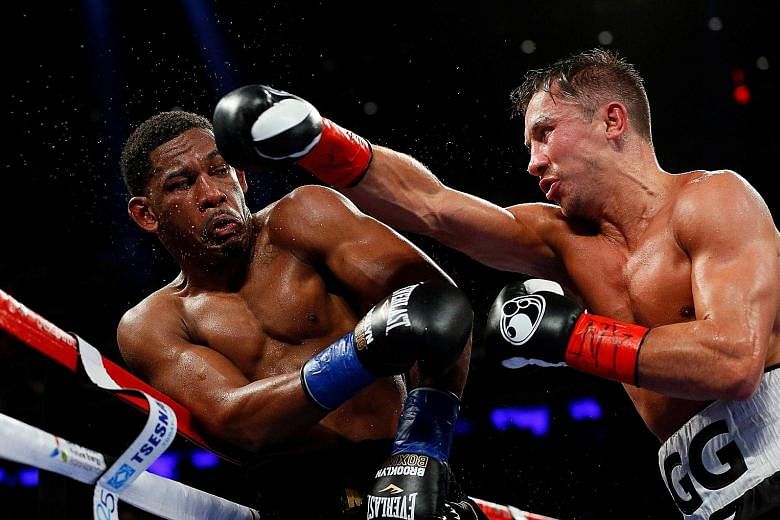Unbeaten Gennady Golovkin throwing a punch at Daniel Jacobs, as 19,000 fans watched their middleweight world championship fight.
