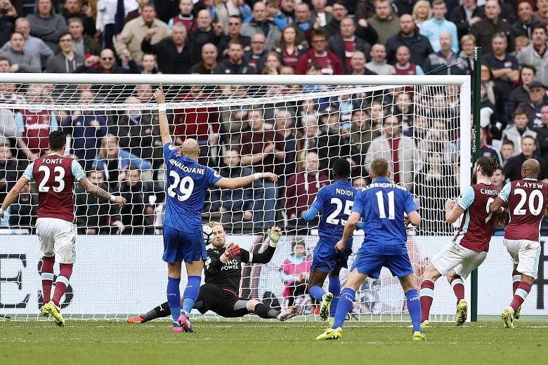 Kasper Schmeichel saving from Andy Carroll as the goalkeeper helped Leicester repel late West Ham attacks for their first away league win in nearly 12 months. It was the Foxes' fourth victory on the trot after the dismissal of Claudio Ranieri.