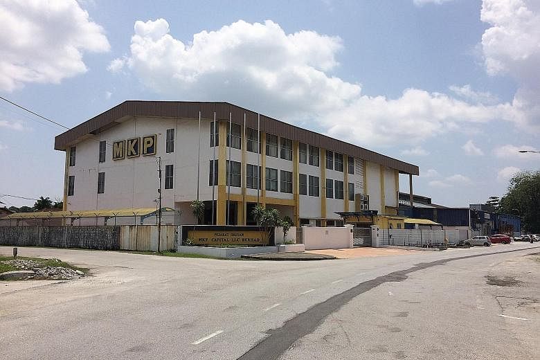 An MKP subsidiary's office (left) is shuttered, with old bills from 2015 left behind. Meanwhile, North Korean partner Han Hun Il's apartment in Kuala Lumpur appeared occupied, but no one answered when The Straits Times visited. Malaysian firm MKP Hol