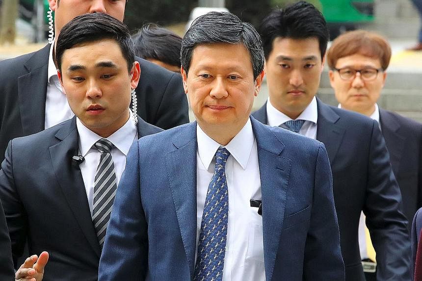 The 94-year-old Lotte Group founder Shin Kyuk Ho and his sons - chairman Shin Dong Bin (left, above) and Shin Dong Joo - all wound up in court yesterday as their trial began. Members of the family have been embroiled in accusations of embezzlement, b
