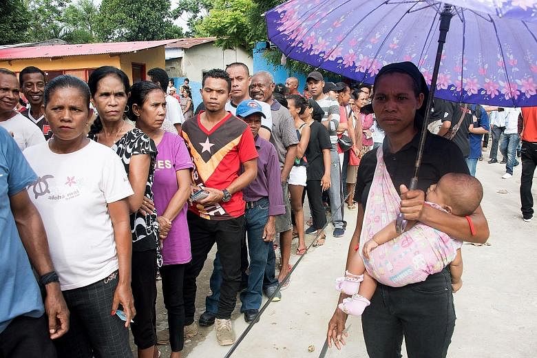 An official with a ballot paper in the capital of Dili, where lines formed as many waited to vote in the fourth presidential election since Timor Leste won its independence from Indonesia in 2002.