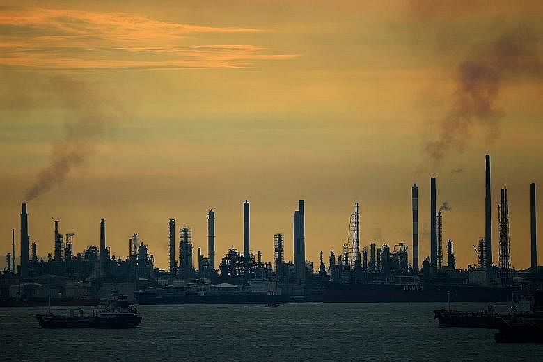 An oil refinery on Pulau Bukom. The added burden from the carbon tax will reduce refineries' competitiveness in the region, said one expert.