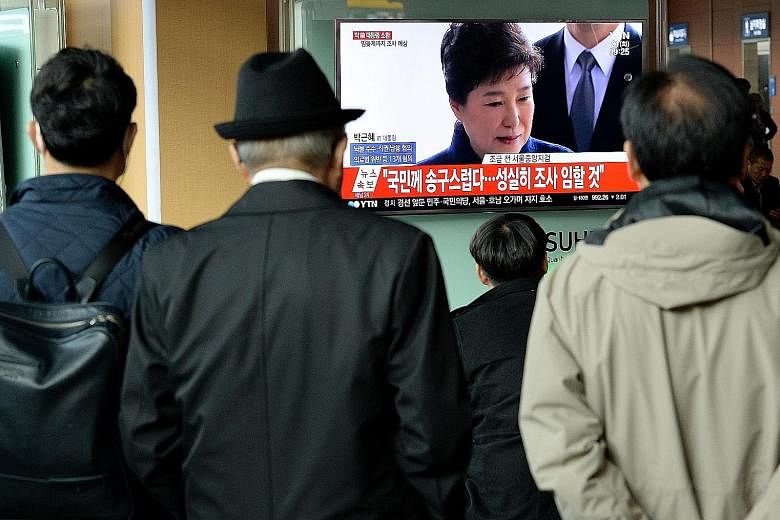 South Koreans watching TV coverage of the investigation into Ms Park Geun Hye's alleged involvement in a corruption and influence-peddling scandal that led to her downfall.