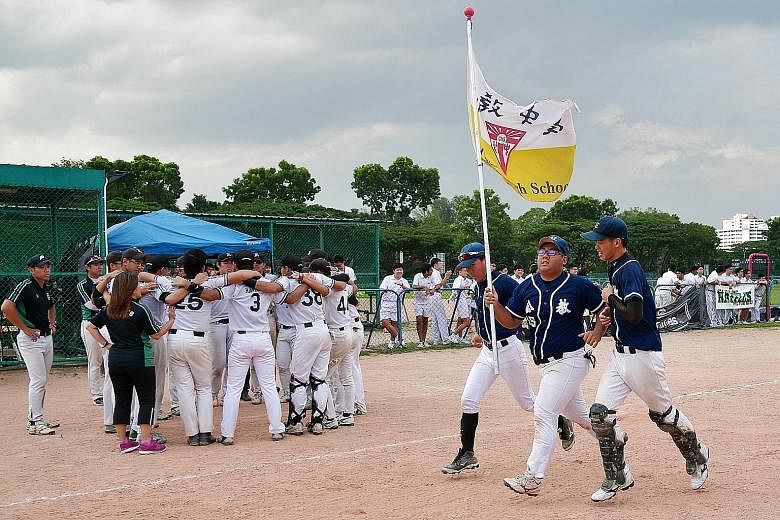 Left: CHS catcher Joshua Tan (No. 13), tagging RI's Zachar Oh (No. 25) during the bottom of the fourth inning. Below: CHS boys celebrating with a lap of honour after beating eight-time defending champions RI to win their first Schools National B Divi