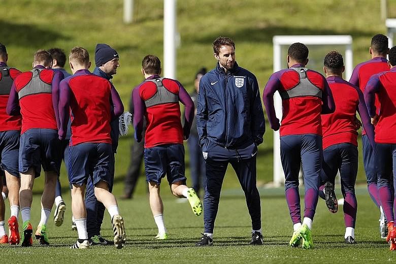 England manager Gareth Southgate (facing camera) during a training session yesterday. Striker Jermain Defoe, 34, is in line to return after more than three years for today's friendly against World Cup champions Germany.