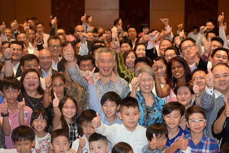 PM Lee and Mrs Lee posing for a group photo yesterday with some of the Singaporeans and their families living in Ho Chi Minh City, Vietnam. Mr Lee told them that the fact they are all there shows that the adventurous spirit in Singapore is alive and 