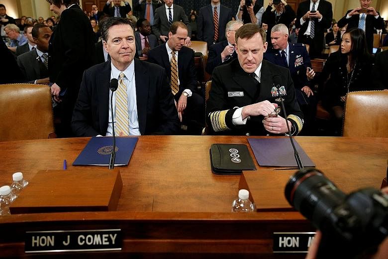 Mr James Comey (left), with National Security Agency director Mike Rogers at a House Intelligence Committee hearing on Monday, confirmed that the FBI is investigating Russia's interference in the US presidential election last year. He said there was 