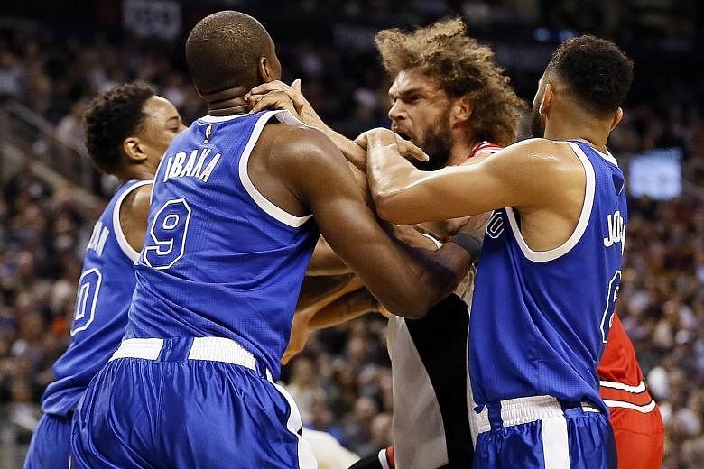 A fight breaks out between Raptors forward Serge Ibaka (No. 9) and Bulls centre Robin Lopez in the third quarter of their NBA clash. Both players were ejected before Toronto completed a comeback to win 122-120 in overtime.
