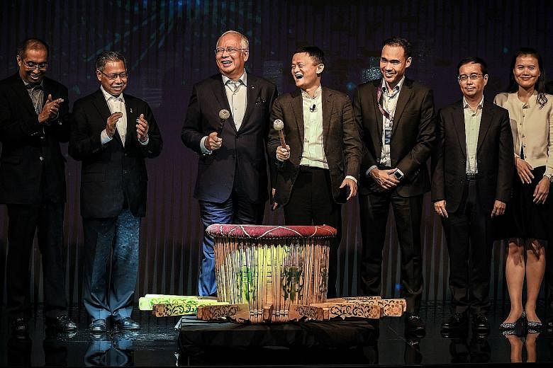PM Najib and Mr Ma (holding microphones) launched Malaysia's Digital Free Trade Zone yesterday.