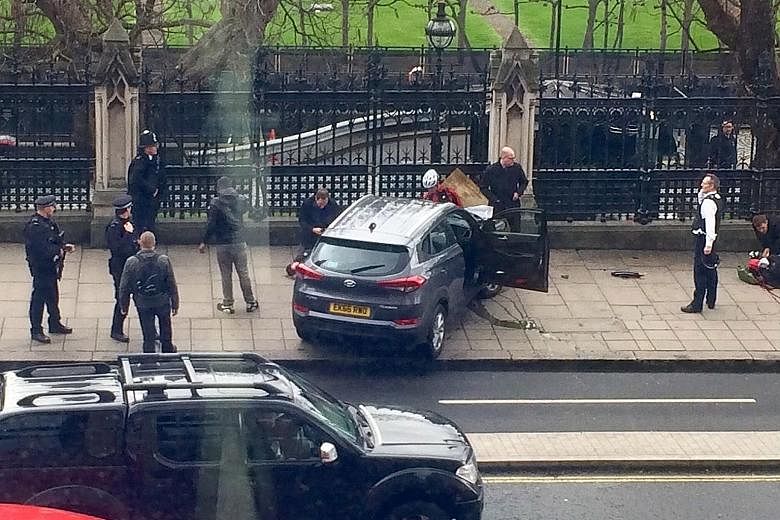 Emergency workers attending to the alleged assailant, who was shot by police after he reportedly made his way into the Parliament grounds and attacked an officer. Members of the public being taken to safety near Westminster Bridge, where eyewitnesses