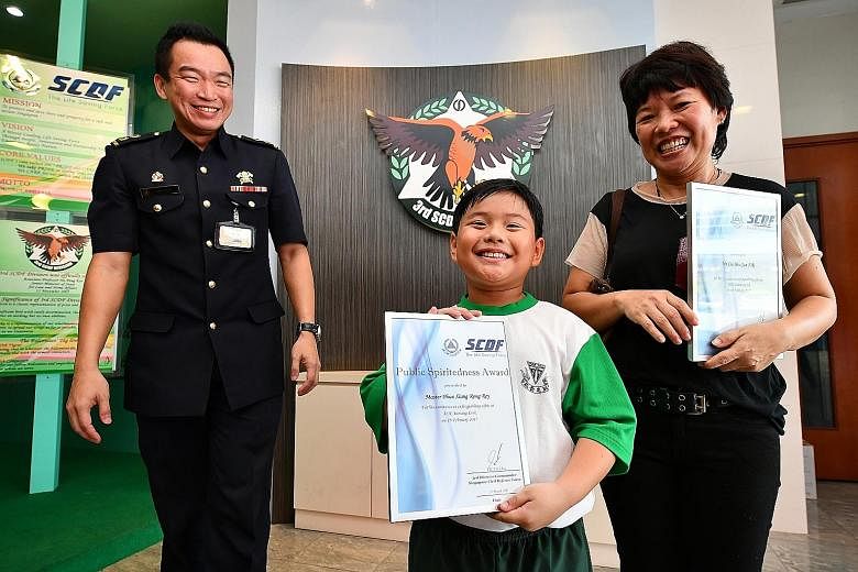 Lt-Col Chua, with Ms Liu and her son Phua Xiang Rong Rey. Every year, the SCDF responds to around 1,500 cases of rubbish chute fires.