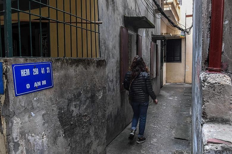 Madam Nga walking towards a Hanoi residential quarter where her daughter was molested in January. The suspect was nabbed this month after public outrage spilt onto Facebook.