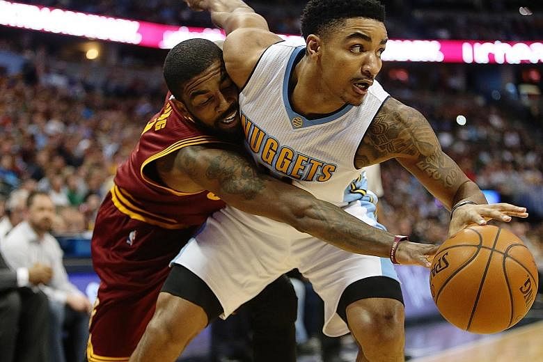The Nuggets' Gary Harris fending off the Cavs' Kyrie Irving. With Cleveland's loss to Denver, Boston are closing in for top billing in the East.