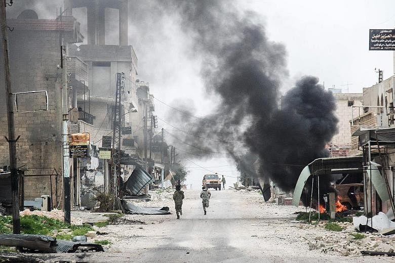 A plume of smoke from a burning tyre rising amid the destruction in the Syrian town of Tayyibat al-Imam in Aleppo on Wednesday. Mr Tillerson did not make clear where the "interim zones" were to be set up, or how they would work, but creating such saf