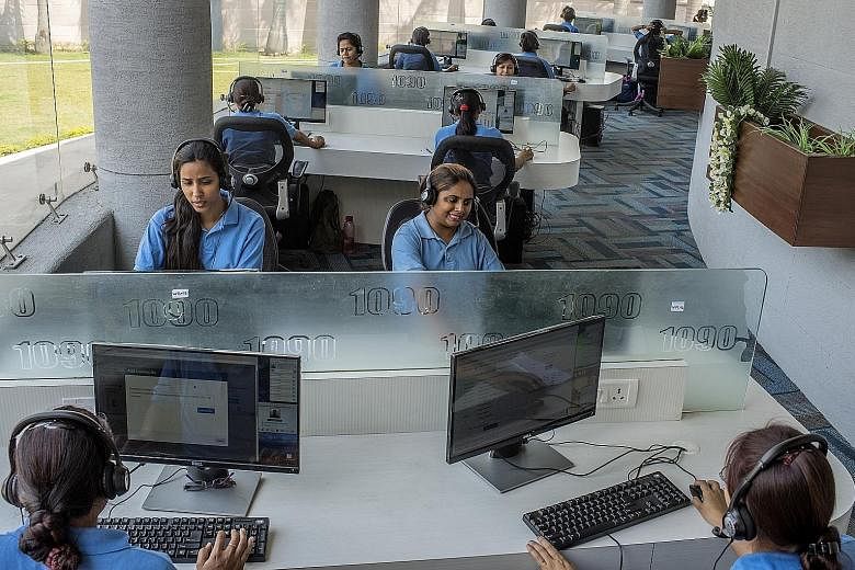 Staff at a police call centre in Lucknow, India, where women have been calling in to complain of persistent calls from strange men. The rise in mobile phone use has made it easier for men from traditional societies to contact women.