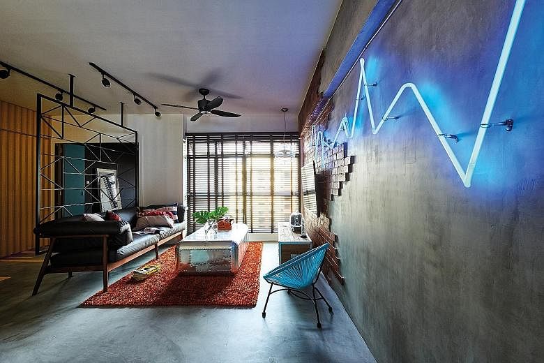 The customised neon light fixture in the living room, set against a faux brick and concrete screed feature wall, is inspired by stock graphs.