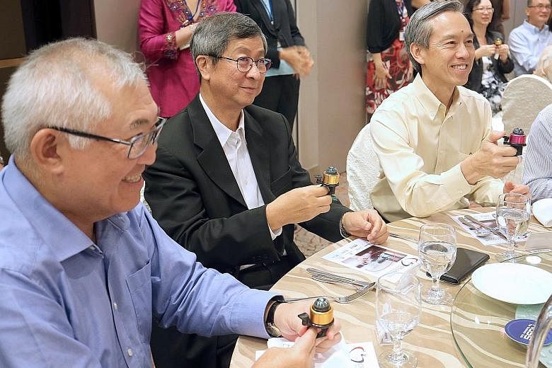 Former labour chief Lim Boon Heng (centre), with FairPrice chairman Bobby Chin (far left) and Centre For Seniors chairman Tan Kian Chew, ringing a compass bell yesterday to launch a training programme by the Centre For Seniors.