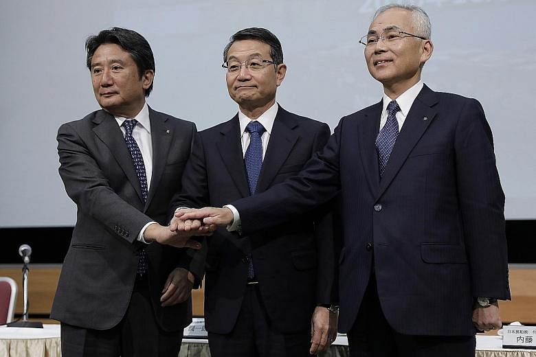 From left: Kawasaki Kisen Kaisha's president and CEO Eizo Murakami, Mitsui OSK's president and CEO Junichiro Ikeda and Nippon Yusen Kabushiki Kaisha's president Tadaaki Naito at a news conference in Tokyo last Oct 31.
