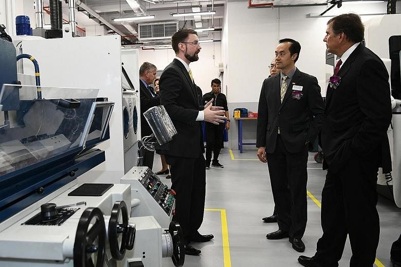 An Emerson spokesman explaining the features of the new additive manufacturing centre to Dr Koh Poh Koon, Minister of State for Trade and Industry, and Emerson chief executive David Farr.