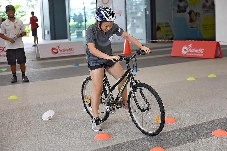 The six-hour Learn-to-Cycle course focused on how to ride a bike around a circuit. Participants were given a safety briefing and taught how to properly put on equipment, such as helmets and knee pads. St Anthony's Canossian Secondary students taking 