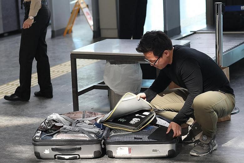 A man stowing away his laptop at Turkey's Ataturk Airport.