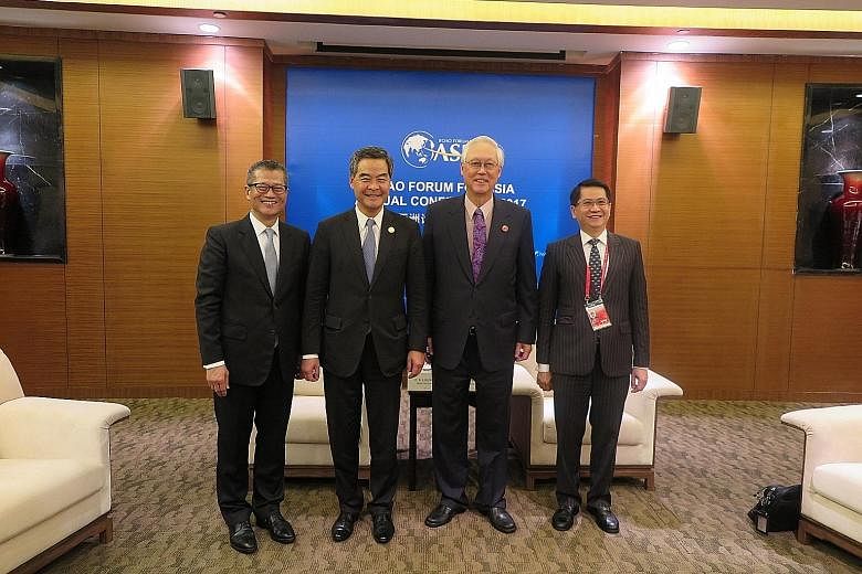ESM Goh Chok Tong (second from right) and Hong Kong's Chief Executive Leung Chun Ying (second from left) met on the sidelines of the forum yesterday. Also in the picture are Hong Kong's Financial Secretary Paul Chan (far left) and Singapore's Ambassa