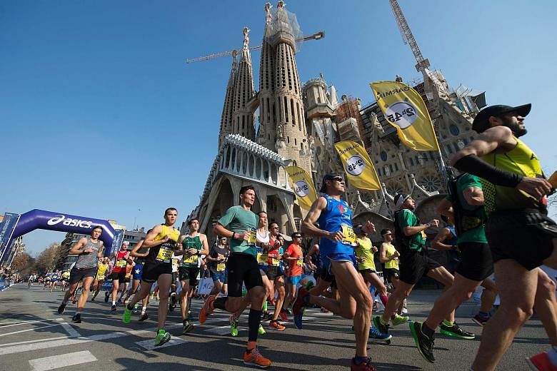 Competitors in the Barcelona Marathon pass the Sagrada Familia church designed by Spanish architect Antoni Gaudi. Chasing the landmark achievement of a two-hour marathon is possible, concludes a recent US study.