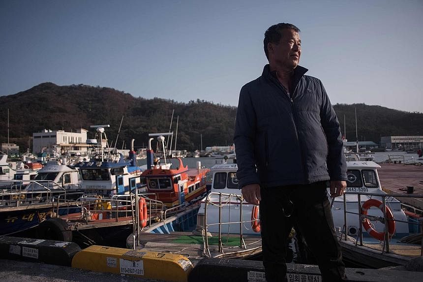 Business is down by half, according to motorboat captain Park Tae Il, as anglers - his main clients - avoid the area where the ferry sank three years ago. "Fishermen call it the devil's water. The atmosphere is cold because so many young lives were l