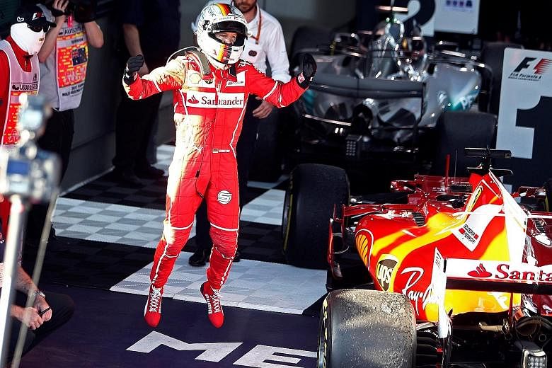 Ferrari's Sebastian Vettel celebrating after his win at Albert Park yesterday. Despite Mercedes' Lewis Hamilton starting on pole, he lost the lead to the German driver after a pit stop.