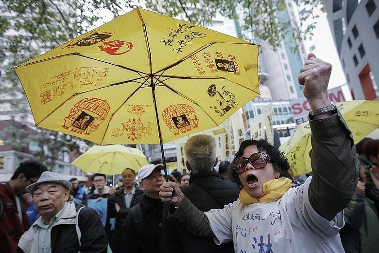 It was V for victory for pro-China supporters after Mrs Lam's win, while pro-democracy supporters, holding yellow umbrellas, the symbol of their movement, rallied near the Convention Centre in Hong Kong yesterday.