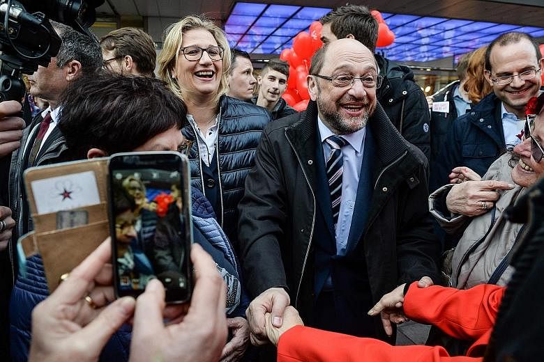 Mr Martin Schulz and his fellow Social Democrats on the campaign trail in Saarland last week, ahead of yesterday's vote in the small German state. The new leader has re-energised the centre-left party with a promise to tackle inequality, a pledge tha