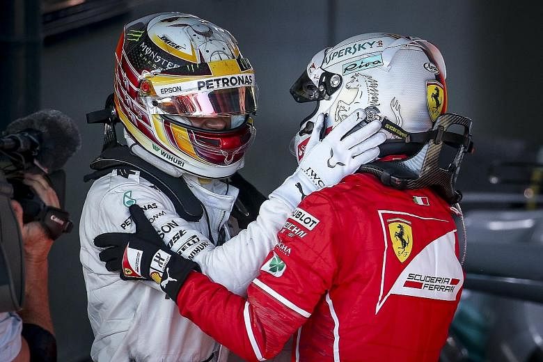Mercedes' Lewis Hamilton (left) congratulating Sebastian Vettel after the Ferrari driver beat him by nearly 10 seconds.