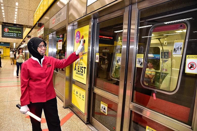 Service ambassador Sabariah Mail waving at passengers during the 10-minute halt last night. The new signalling system will allow trains to run at faster intervals of 100 seconds, instead of the current 120 seconds.