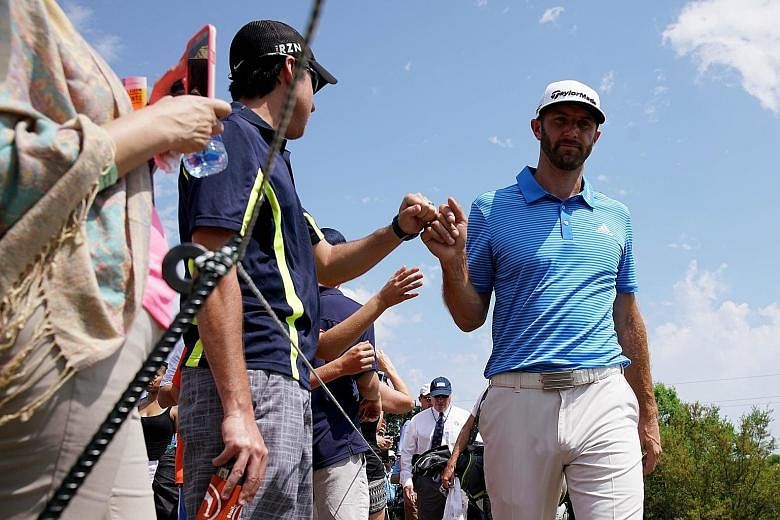 Dustin Johnson gives a fan a fist bump at the WGC-Match Play. The in-form world No. 1 is tipped to be a handful at the Masters.
