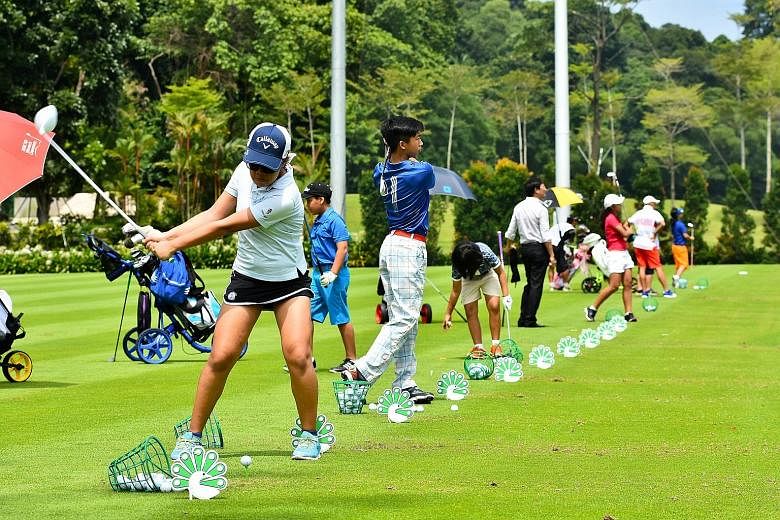 Promising golfers teeing off at the driving range at Sentosa Golf Club. About 70 locals took part in the inaugural Singapore Golf Association's (SGA) Junior Invitational. The nine-hole tournament at the Serapong Course featured four divisions (Under-