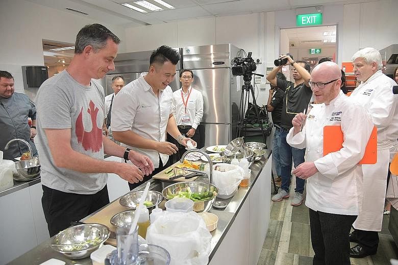 Michael di Placido (far left) from Stellar Restaurant and Nixon Low from Jiakpalang Eating House take part in a 30-minute cooking challenge as Gary Maclean (second from right) and Mr Willie McCurrach look on, at the opening of the MDIS baking and cul