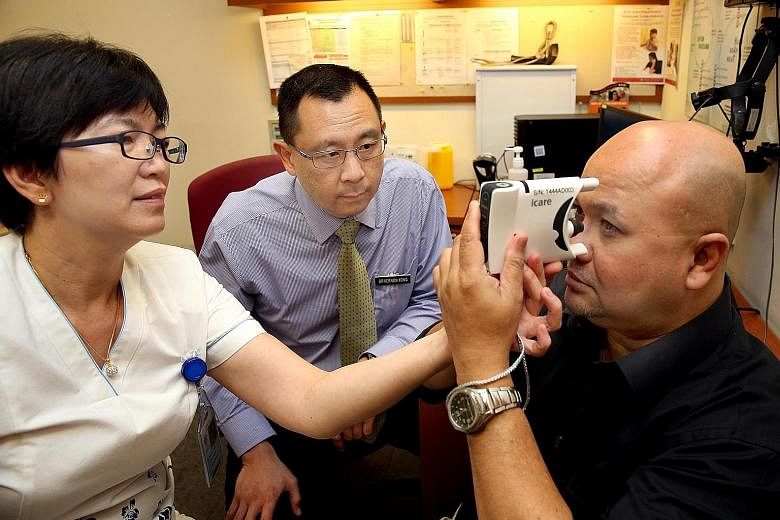 Assistant nurse clinician Soo Hoo Wai Cheong and Dr Vernon Yong helping patient Shaun Nathan use a handheld device to measure his eye pressure. With the device, which can be used at home, glaucoma patients do not have to make multiple trips to the ho