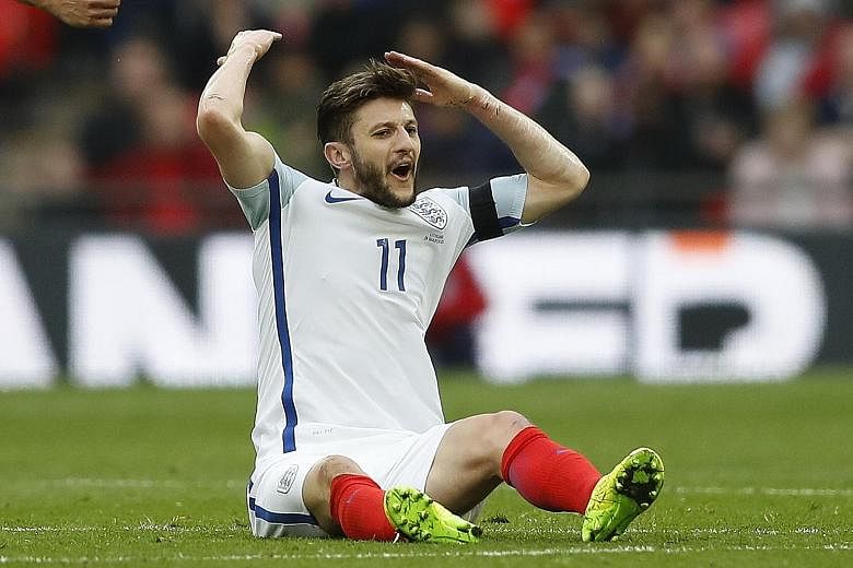 England's Adam Lallana reacts after being fouled during England's World Cup qualifier against Lithuania.