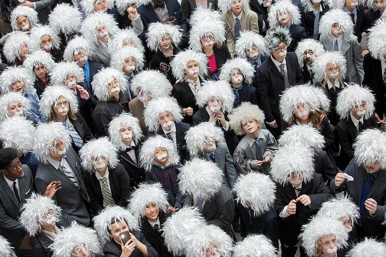 Donning matching white wigs and moustaches, 404 people set a new Guinness World Record for the "largest gathering of people dressed as scientist Albert Einstein" in Toronto, Canada, on Tuesday, according to organisers of the Einstein Legacy Project, 