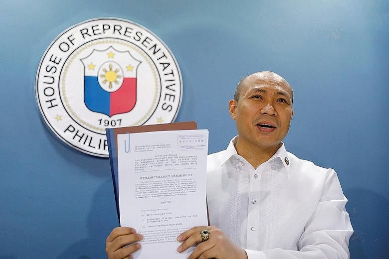 Representative Gary Alejano showing the media a copy of a supplemental impeachment complaint against President Rodrigo Duterte yesterday, over the latter's "defeatist stance" in the territorial dispute with China.