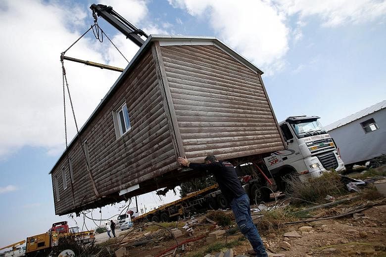 A pre-fabricated home being removed from the illegal Israeli settler outpost of Amona in the West Bank in February. Israel plans to build a new settlement as compensation for the 40 Amona families evicted.