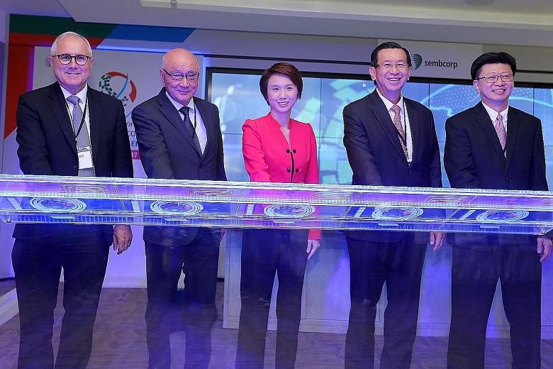 Ms Low with (from left) Sembcorp Industries' Mr Neil McGregor, non-executive and non-independent director and chief executive-designate; Mr Ang Kong Hua, chairman; Mr Tang Kin Fei, group president and CEO; and Mr Ng Meng Poh, executive vice-president