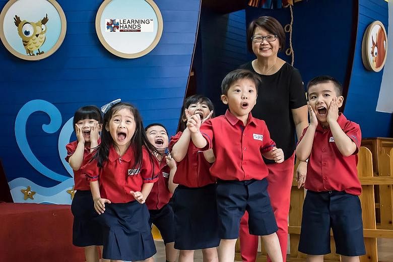 Ms Tan with children at the Learning Hands pre-school she runs in North Jakarta. It offers a Singapore-style curriculum to middle-class Indonesians, who pay $4,000 a year in school fees.
