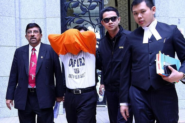 The businessman leaving the court in Putrajaya with two of his lawyers, Datuk K. Kumaraendran and Mr J.R. Tey, and a Malaysian Anti-Corruption Commission officer.