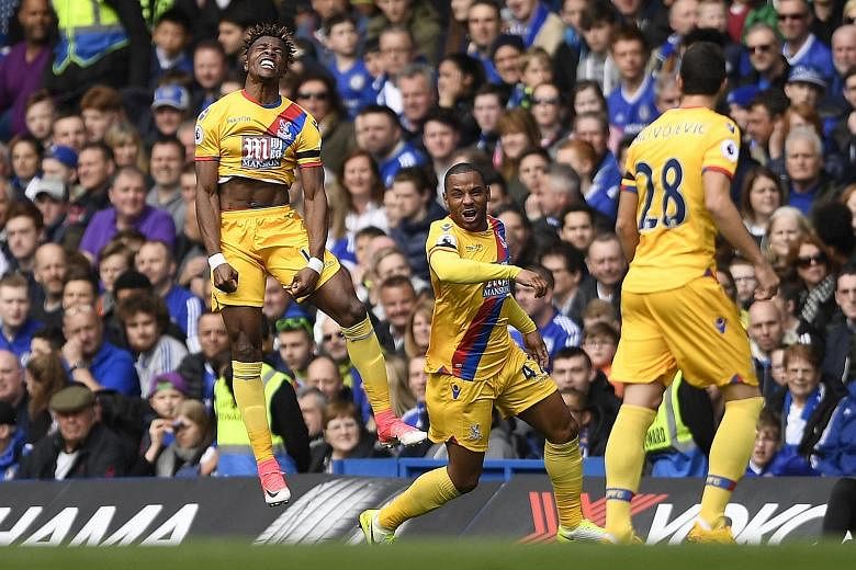 Joy for Crystal Palace's (from left) Wilfried Zaha as he celebrates his equaliser against league leaders Chelsea with Jason Puncheon and Luka Milivojevic.