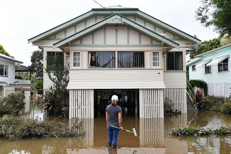 Where to begin the cleanup? The couple are among residents in the town of Lismore, New South Wales, yesterday who are returning to their homes as the flood water in their area recedes. Tens of thousands of people have been evacuated from a string of 
