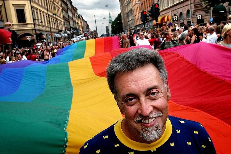 American artist Gilbert Baker leading the Stockholm Pride Parade in 2003 with a 250m-long version of his rainbow flag.