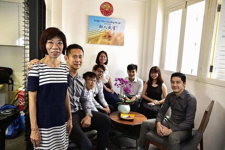 Ms Sim Lay Koon (left), now a senior account associate at consultancy firm Bridge 2 Biz Consulting, with (from left) managing director Henry Ong and colleagues Tan Zheng Bang, Chang Si Jie, Lek Mei Ting, Sean Tan, Woan Yng and Ryan Chan. Ms Sim's exp