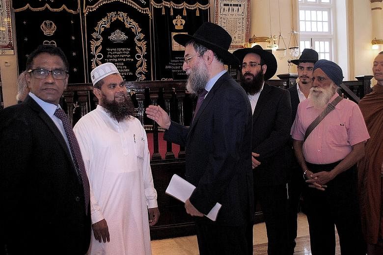 Imam Nalla Mohamed Abdul Jameel speaking to Rabbi Mordechai Abergel at the Maghain Aboth Synagogue yesterday, where he extended his unconditional apology and said he must bear full responsibility for his actions.