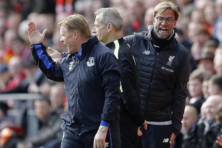 Everton manager Ronald Koeman (left) and Liverpool counterpart Jurgen Klopp (right) react during a passionate Merseyside derby at Anfield. The hosts won 3-1 but lost key forward Sadio Mane to injury.